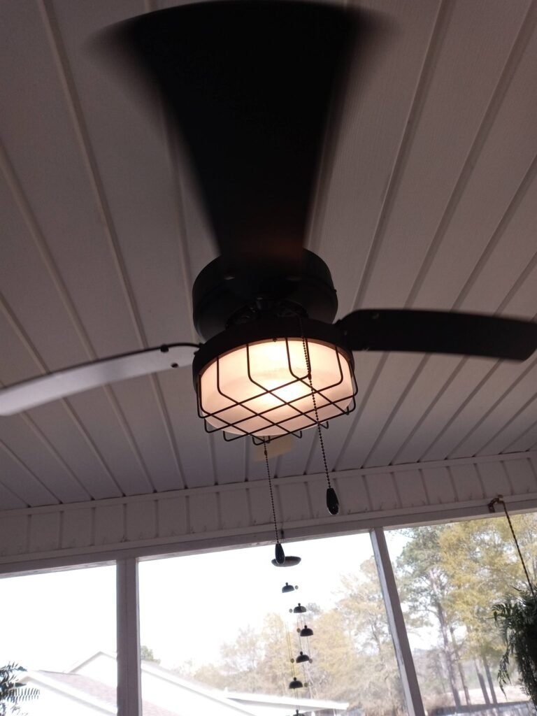 Ceiling fan with working light fitting after repair on a covered porch