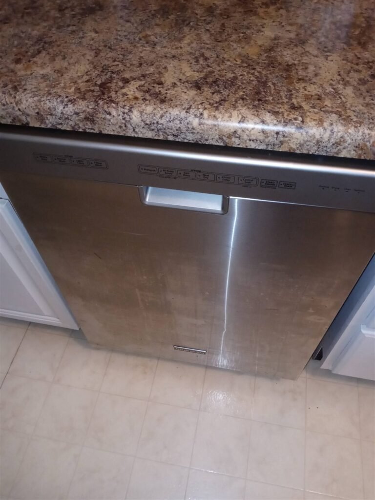Stainless steel dishwasher back in service under a kitchen counter in Fayetteville NC