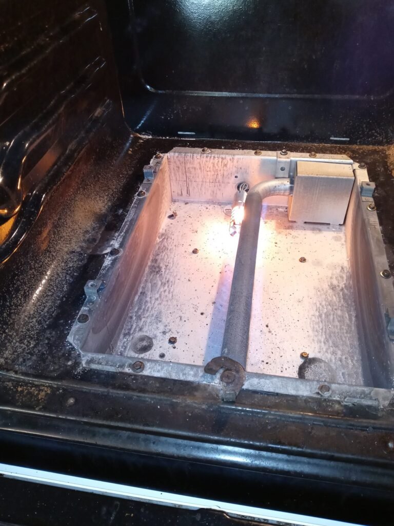 Oven bake element glowing red during a test after repair